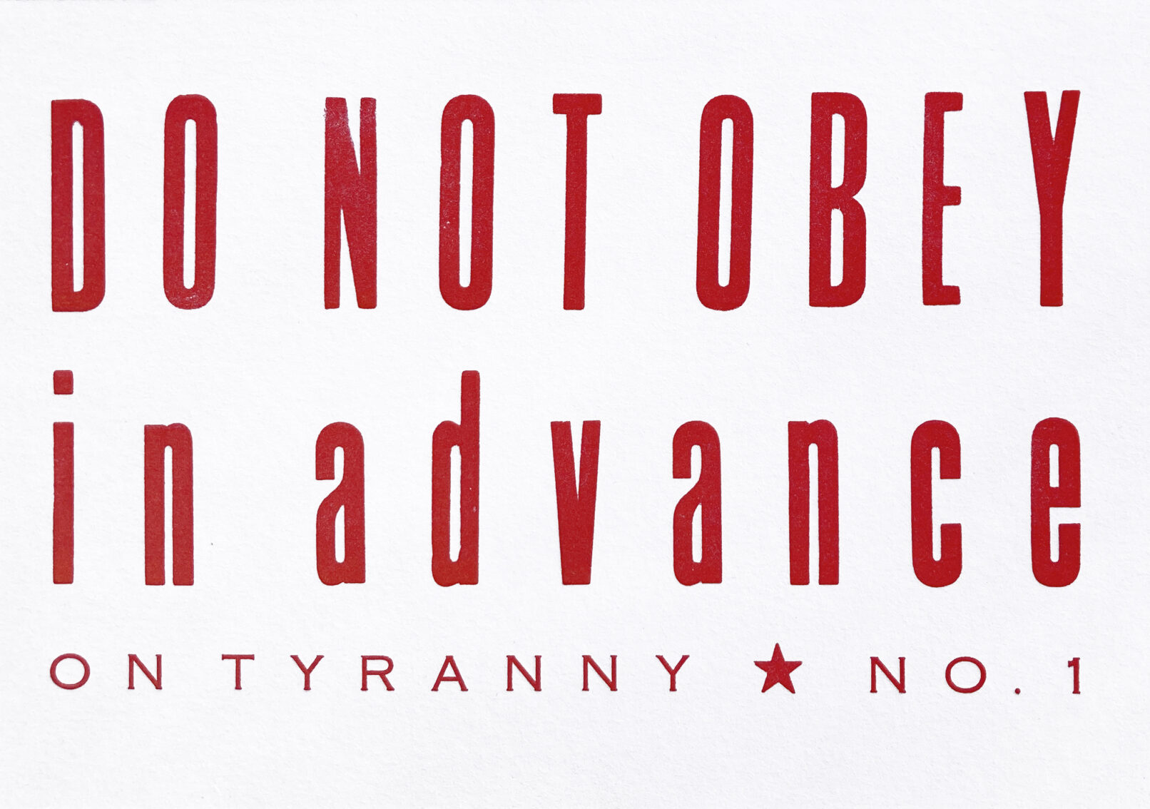 Letterpress print in red ink with text that reads "Do Not Obey in Advance On Tyranny No. 1."