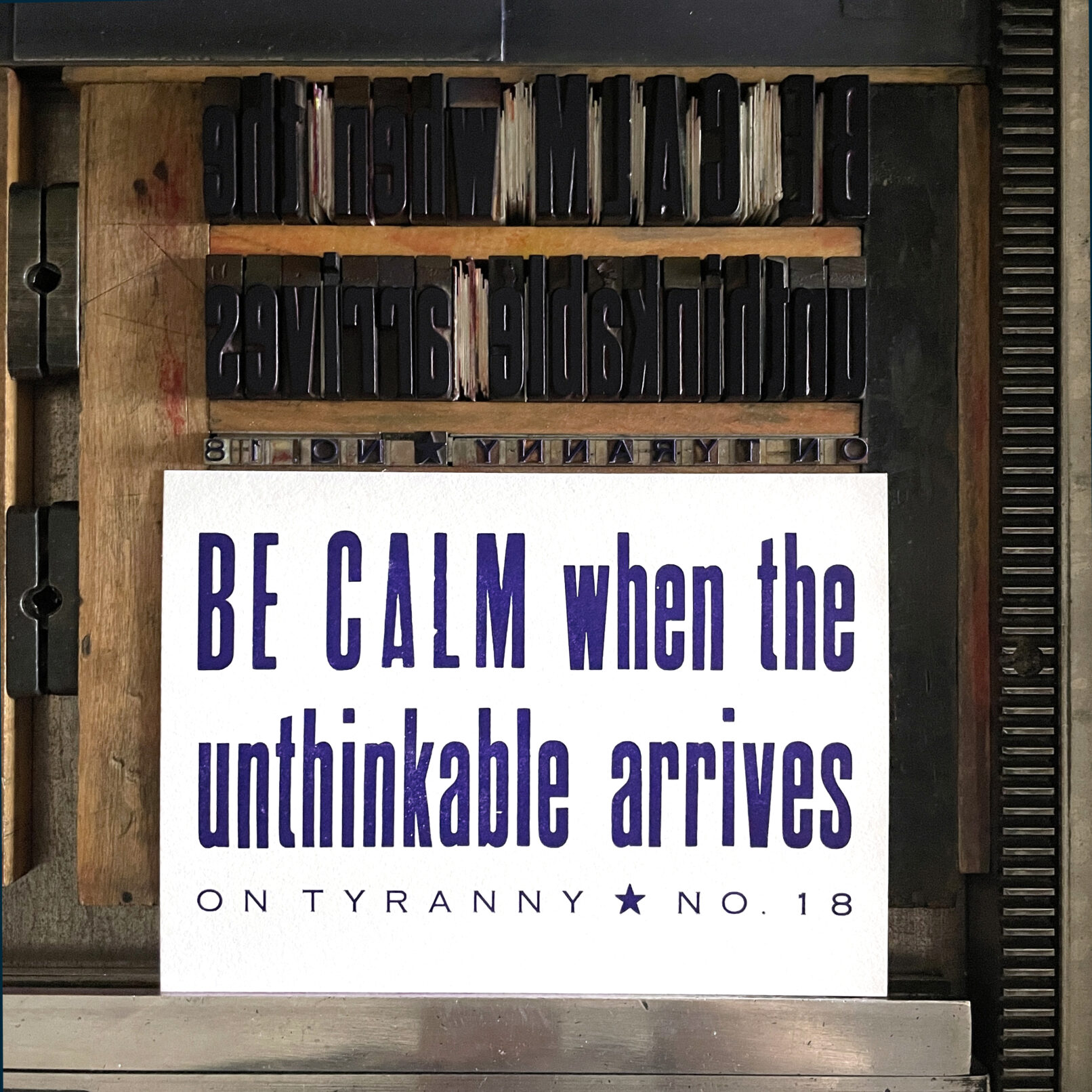 Letterpress print on Vandercook press bed. Printed in purple ink on white paper, the text reads "Be Calm When The Unthinkable Arrives On Tyranny No. 18."