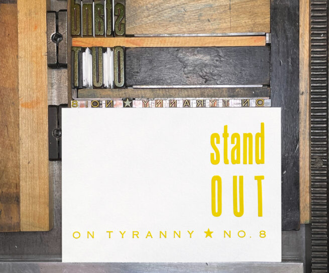 Letterpress print on Vandercook press bed. Printed in yellow ink on white paper, the text reads "Stand Out On Tyranny No. 8"