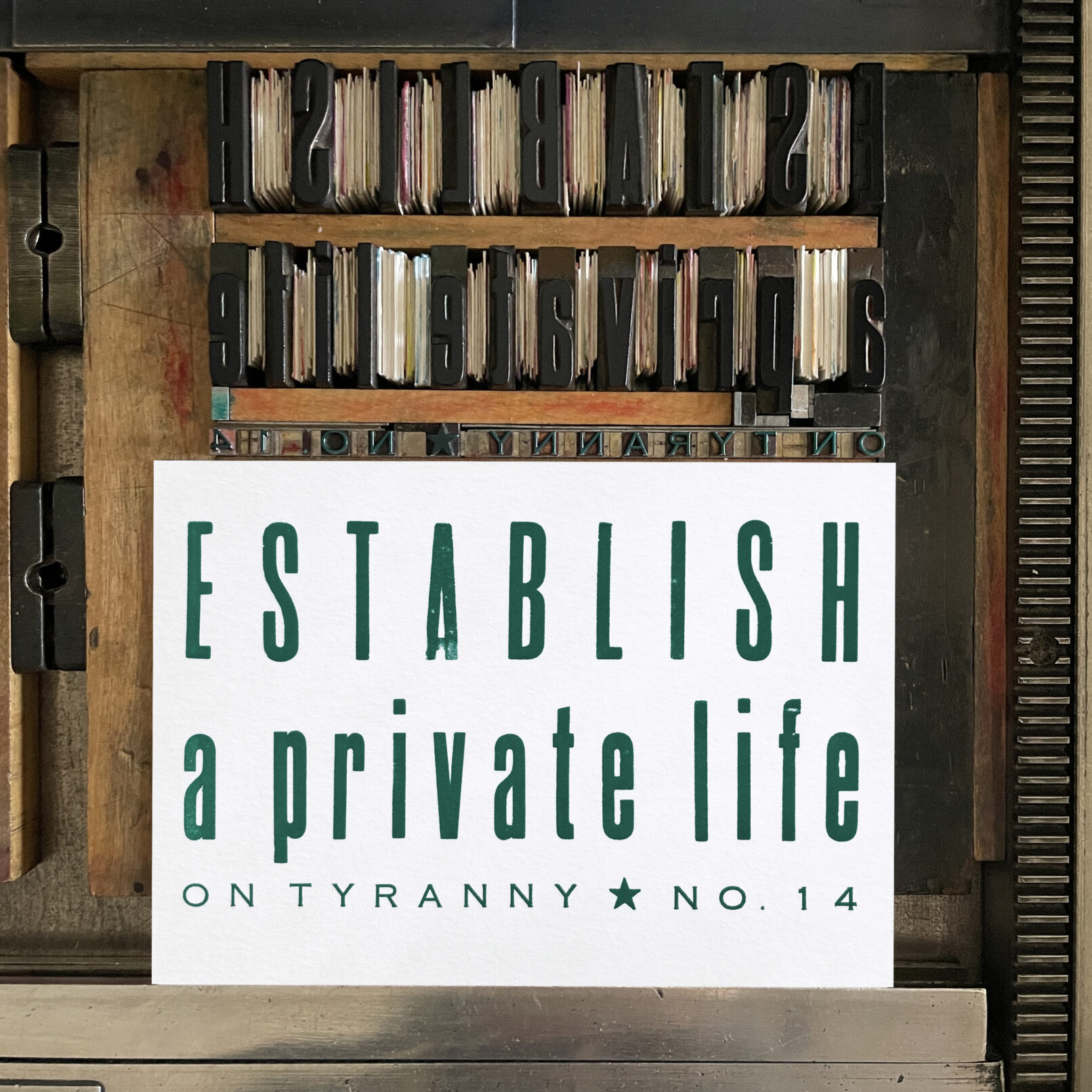Letterpress print on Vandercook press bed. Printed in teal green ink on white paper, the text reads "Establish a Private Life On Tyranny No. 14."