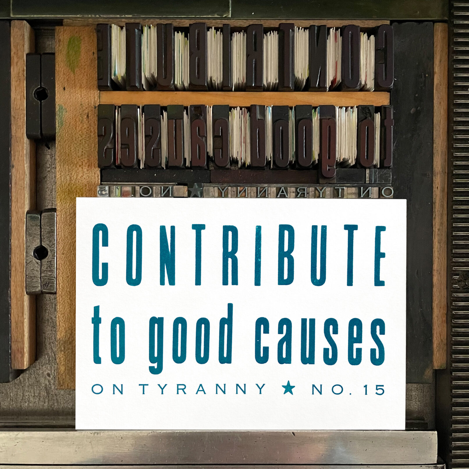 Letterpress print on Vandercook press bed. Printed in blue ink on white paper, the text reads "Contribute to Good Causes On Tyranny No. 15."