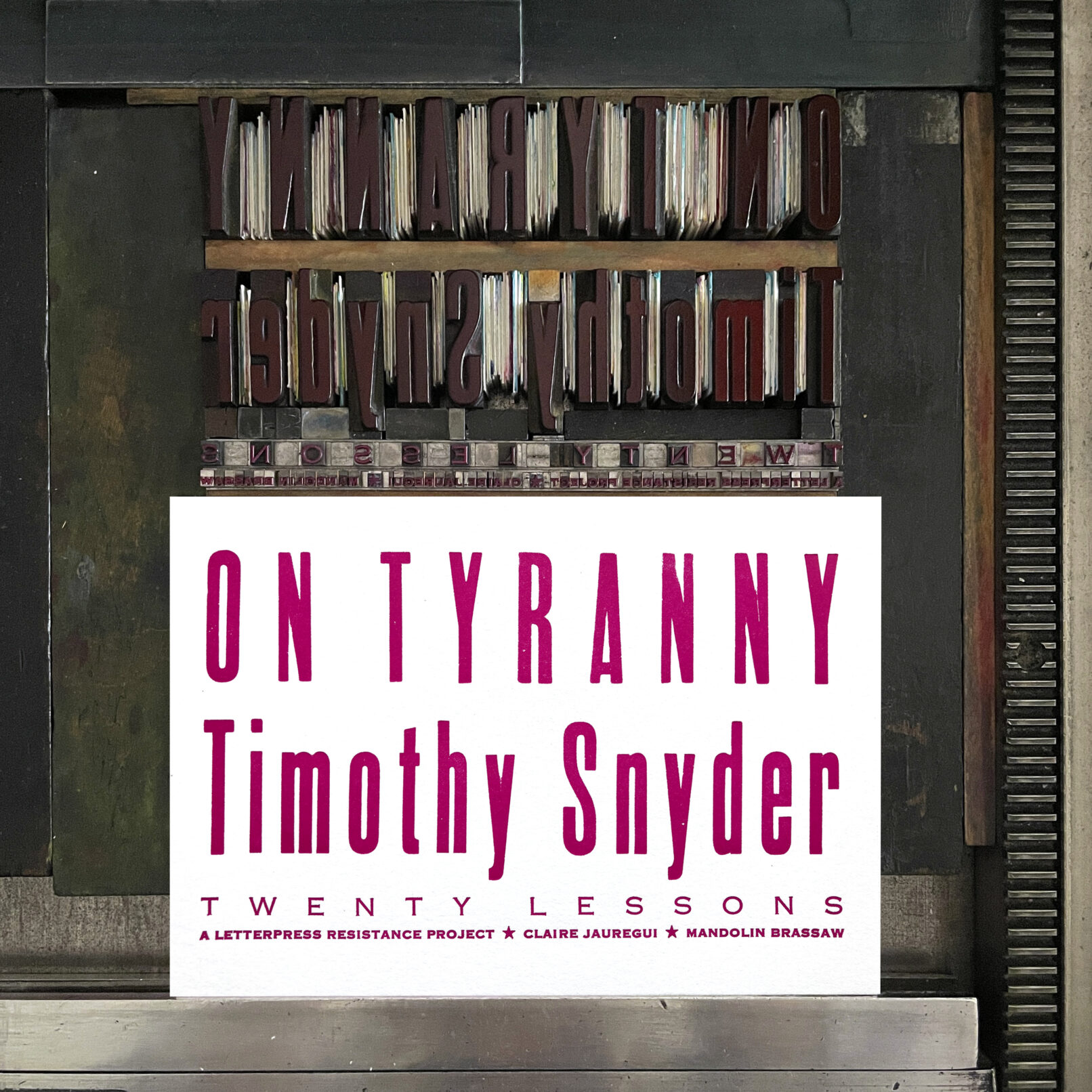 Letterpress print on Vandercook press bed. Printed in magenta ink on white paper with text that reads "On Tyranny Timothy Snyder Twenty Lessons A letterpress resistance project * Claire Jauregui * Mandolin Brassaw"